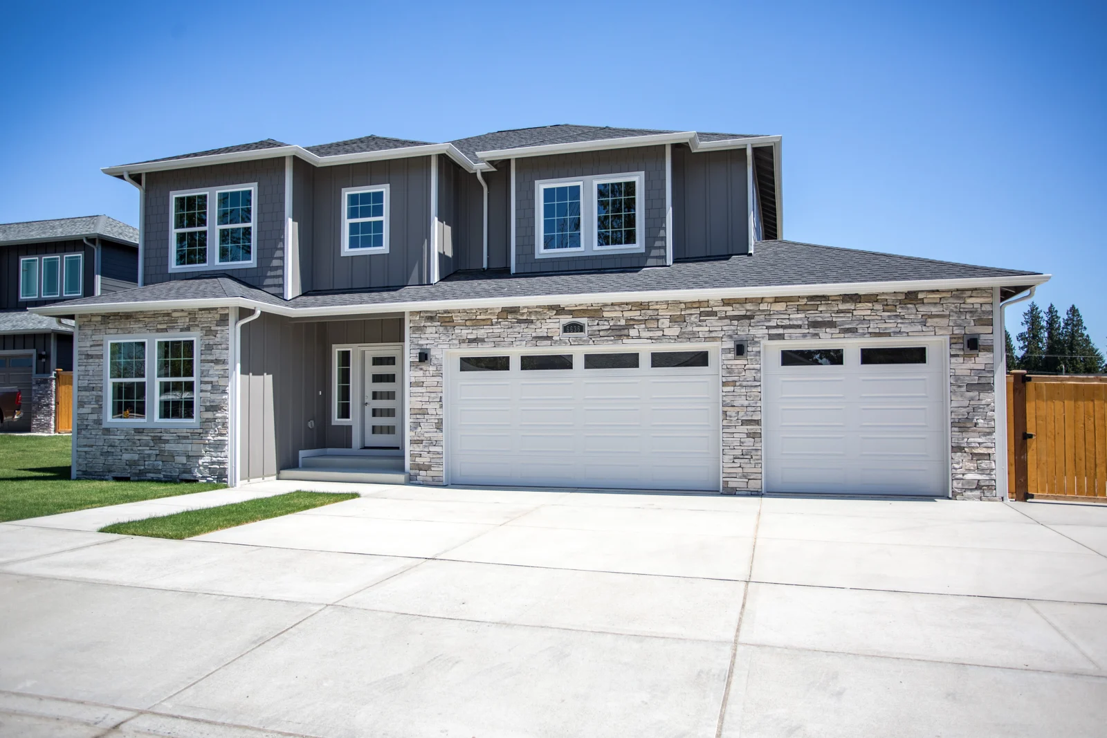 Crestmoor house exterior with stone facade and three-car garage